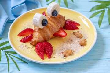 Fun Food for kids. Cute crab croissant with fruit for kids breakfast