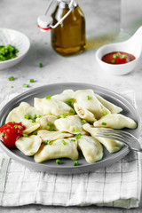 Dumplings, filled with meat. Russian, Ukrainian or Polish dish: varenyky, vareniki, pierogi, pyrohy. Food photo