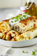 tasty stuffed pancakes crepes with meat closeup. Thin pancakes with fillings. Russian Fried Stuffed Pancakes Blintzes with Meat. Food photo