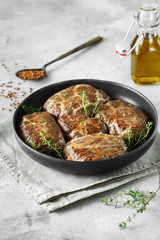 Delicious grilled liver meatballs with buckwheat in a natural casing. Liver patties on the little frying pan served with thyme.