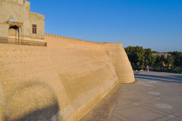 Wall and towers of the ancient citadel in Bukhara "Ark citadel", Uzbekistan.