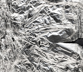 Crumpled aluminum foil with crack background. detail macro
