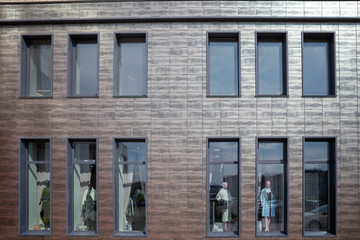 The windows of the store, which are mannequins in fashionable clothes.