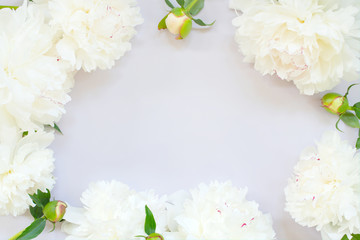 Light tender background with peonies on the table