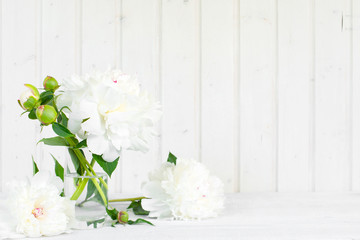 White tender background with peonies on the wooden table