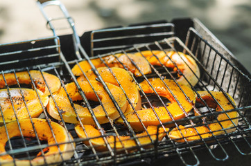 Baked pumpkin slices on the grill grid.
