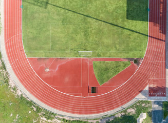 aerial view on Half of soccer field, football field with Numbers on red running track. race track in a stadium.