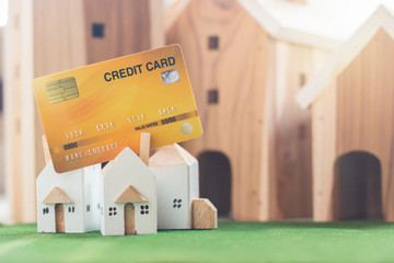 Property investment, Miniature house model with credit card on Simulation grass, Wooden house in...