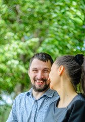 Outdoor portrait of a couple in love. Cheerful smiling couple in summer park