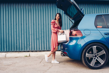 Naklejka premium Young and nice lady, happy with shopping. Dress in summer pocket and packs in hand.