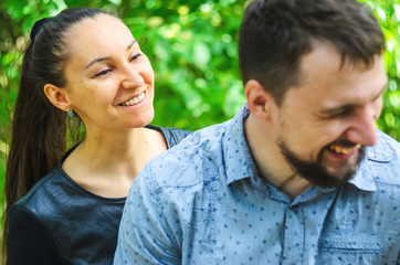 Fototapeta premium Outdoor portrait of a couple in love. Cheerful smiling couple in summer park