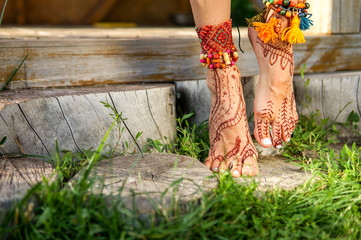 Beautiful legs with accessories and mehendi painting outdoors