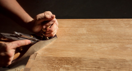 Cabinetmaker produces furniture using planer