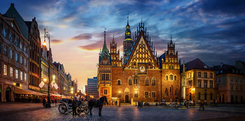 Wroclaw central market square with old houses, Town Hall and sunset, horse and carriage. Panoramic night view, long exposure.  Historical capital of Silesia, Wroclaw (Breslau) , Poland, Europe. - obrazy, fototapety, plakaty