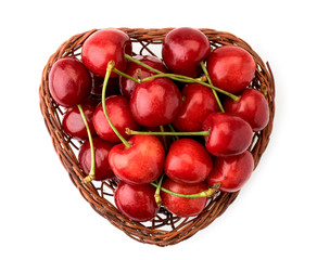 Basket with ripe cherries on a white. The view of the top.