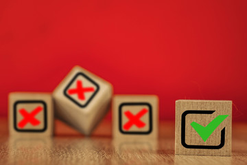 Wooden cubes with drawn marks on the red background