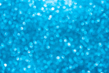 blue Sparkling Lights Festive background with texture. Abstract Christmas twinkled bright bokeh defocused and Falling stars. Winter Card or invitation
