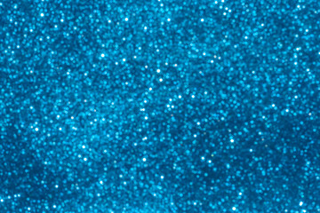 blue Sparkling Lights Festive background with texture. Abstract Christmas twinkled bright bokeh defocused and Falling stars. Winter Card or invitation