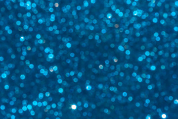blue Sparkling Lights Festive background with texture. Abstract Christmas twinkled bright bokeh defocused and Falling stars. Winter Card or invitation