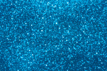 blue Sparkling Lights Festive background with texture. Abstract Christmas twinkled bright bokeh defocused and Falling stars. Winter Card or invitation