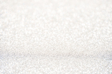 silver Sparkling Lights Festive background with texture. Abstract Christmas twinkled bright bokeh defocused and Falling stars. Winter Card or invitation