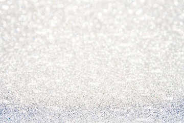 silver Sparkling Lights Festive background with texture. Abstract Christmas twinkled bright bokeh defocused and Falling stars. Winter Card or invitation