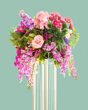 Bouquet of flower on metal stand for decoration isolated on green background with clipping path