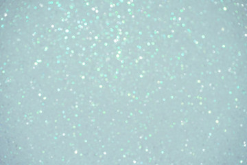 silver Sparkling Lights Festive background with texture. Abstract Christmas twinkled bright bokeh defocused and Falling stars. Winter Card or invitation