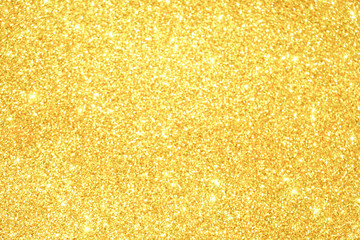 gold Sparkling Lights Festive background with texture. Abstract Christmas twinkled bright bokeh defocused and Falling stars. Winter Card or invitation