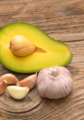  Fresh avocado and garlic on wooden table