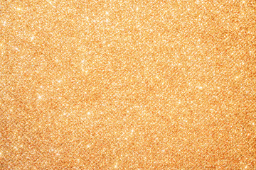 gold Sparkling Lights Festive background with texture. Abstract Christmas twinkled bright bokeh defocused and Falling stars. Winter Card or invitation