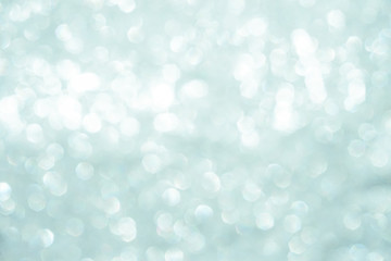 silver Sparkling Lights Festive background with texture. Abstract Christmas twinkled bright bokeh defocused and Falling stars. Winter Card or invitation