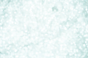 silver Sparkling Lights Festive background with texture. Abstract Christmas twinkled bright bokeh defocused and Falling stars. Winter Card or invitation