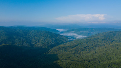 Aerial Landscape View of Caucasus mountain at sunny morning with fog.