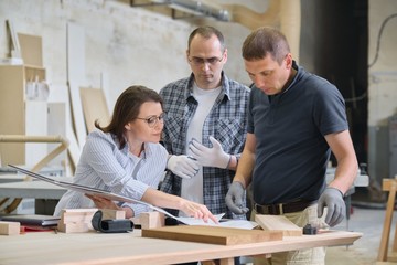 Group of industrial people client, designer or engineer and workers working together on project of...
