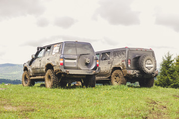 Dirty cars and wheels in the mountains. Swamp on the tires. Trips offroad across Ukraine. View of the Carpathian Mountains. © Yaroslav