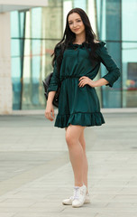 Young female brunette walking in the park.