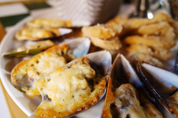 Baked mussels in the shells close-up. Snack to beer.