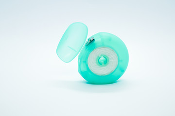 Dental floss in the container on isolated white background. Copy space
