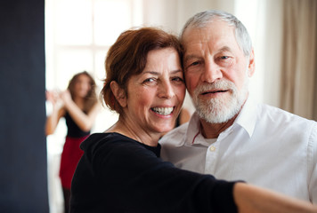 Portrait of senior couple atttending dancing class.