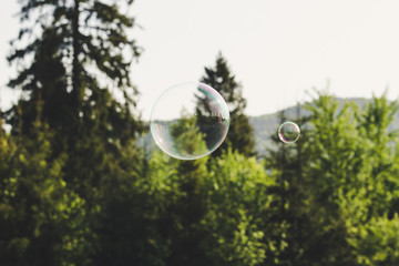 Soap bubbles on the background of the mountains.