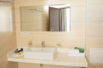Spacious bathroom with toilet, bidet and shower in brown tones.