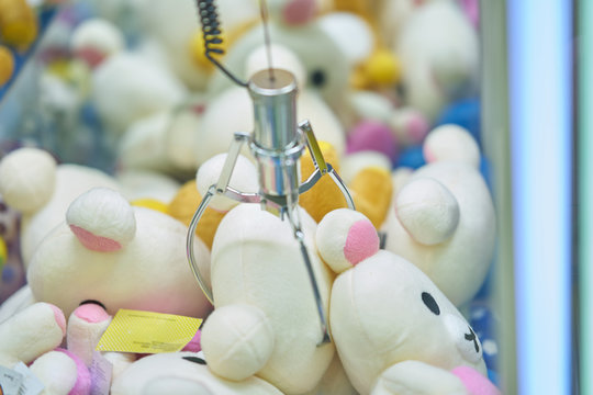 Doll picker or Claw clamp machine in game arcade,clamping doll