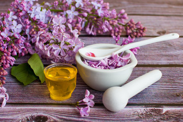Fototapeta na wymiar a jar of fragrant flower honey. Honey saved and lilac flowers.