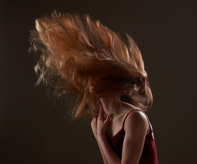Redhead girl sensually swing hair