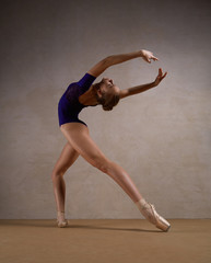 Ballerina dancing in blue clothes and pointe shoes 