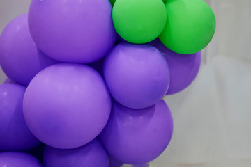 Purple balloon and green balloon on white background
