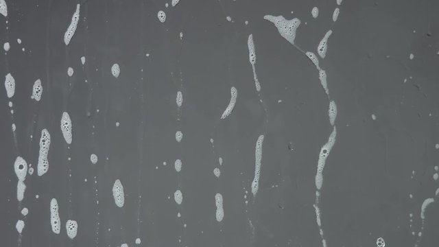 soap bubble foam flow down on crystal. slow motion background soap foam texture