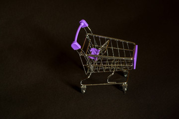 Supermarket trolley on a black background