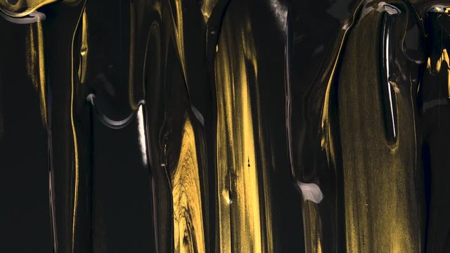 Black and gold acrylic paint flows down onto a white background completely covering it